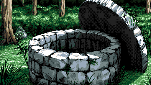 A dry stone well, surrounded by woods. Grass grows in the cracks.